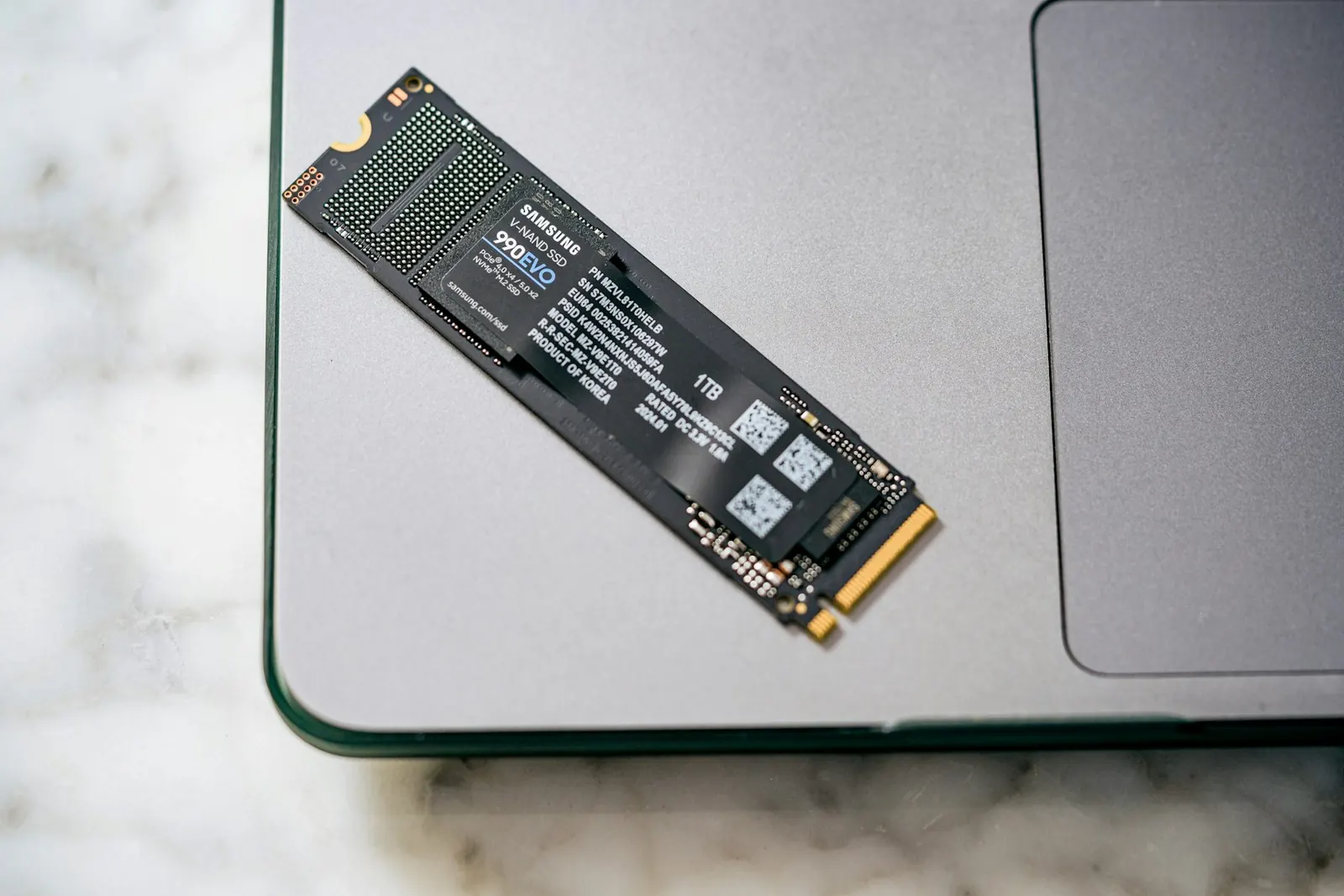 NVMe solid-state drive next to a laptop